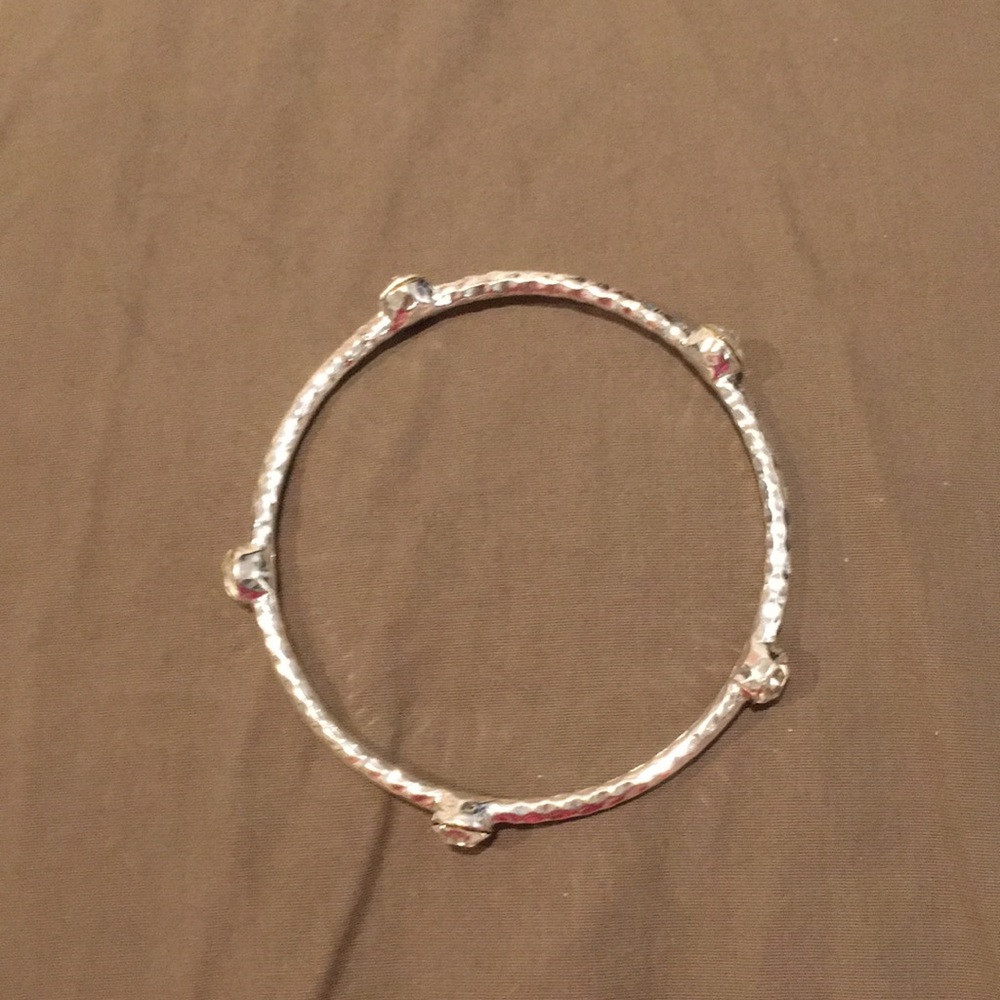 Silver bracelet with white crystals.